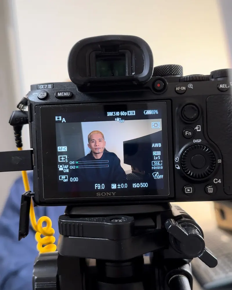 Aaron Lim framed on a camera screen while filming content for his channels
