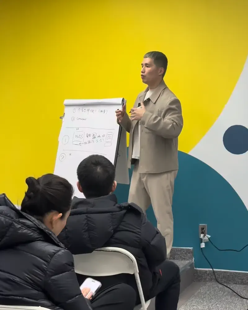 Aaron Lim leading a marketing workshop at a flip chart