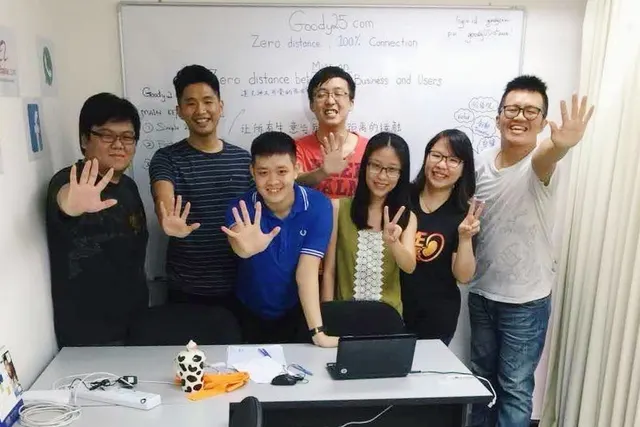 Aaron Lim with the early Goody25 team in front of a whiteboard with the Goody25 mission